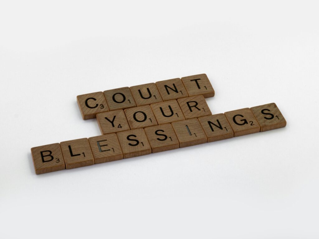 Scrabble tiles forming the phrase "Count Your Blessings" for inspiration.